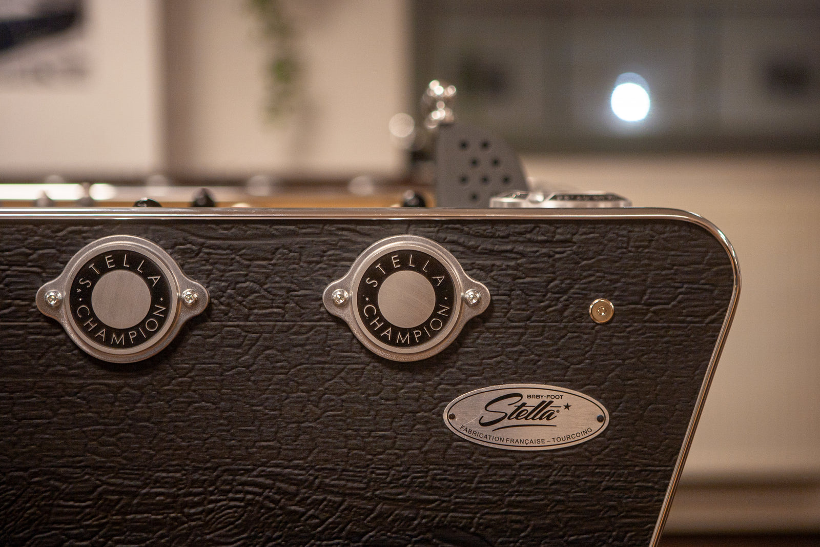Close-up of the Stella Champion logo on the foosball table